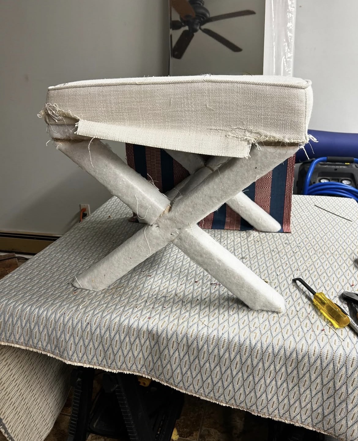 X-frame stool before restoration — stripped to bare frame