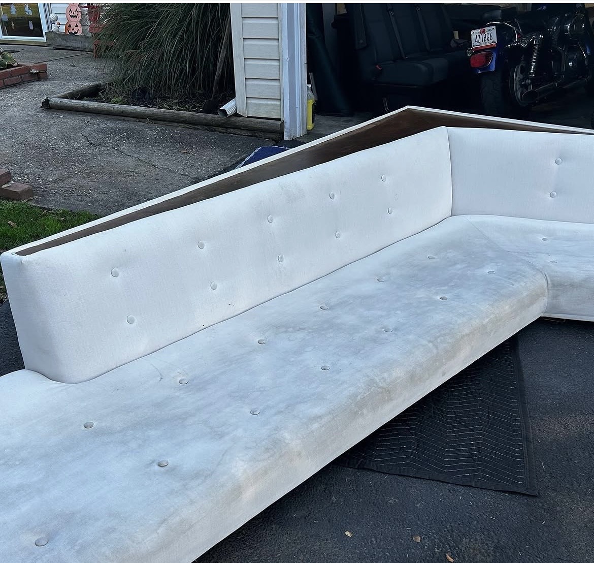 Mid-century L-shaped sectional in original worn white fabric — before restoration