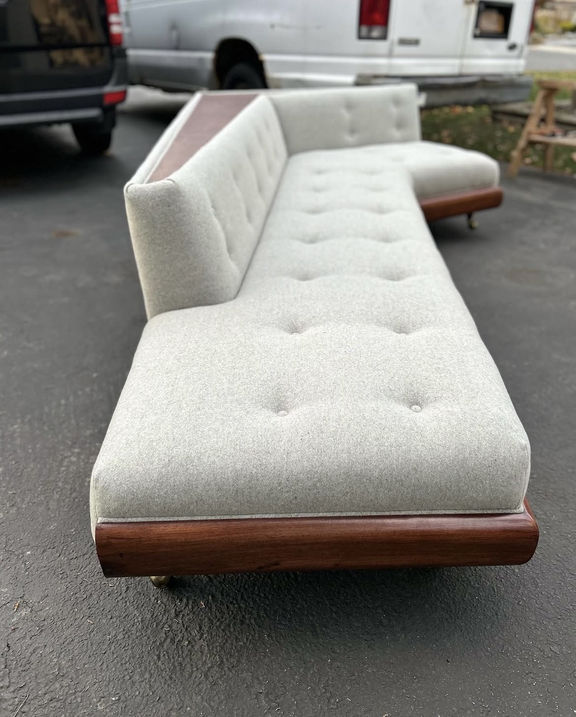 Finished sectional — side angle showing walnut base edge and button-tufted seat depth