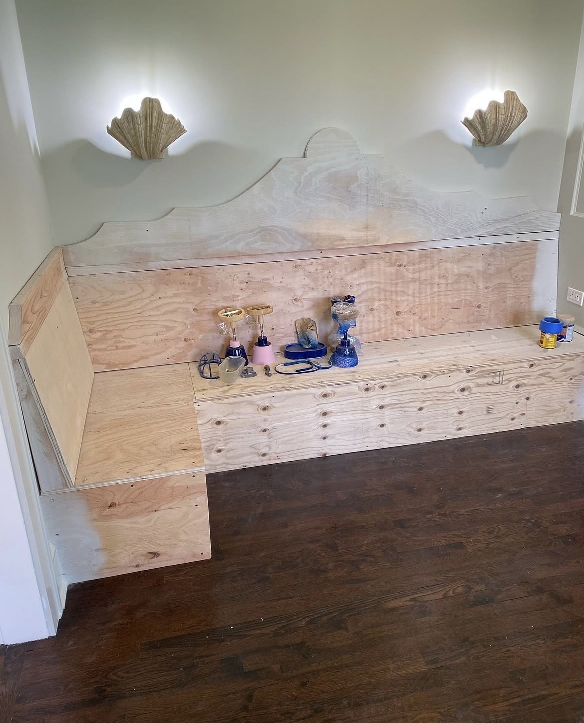 Built-in banquette — raw plywood construction phase showing custom scalloped frame