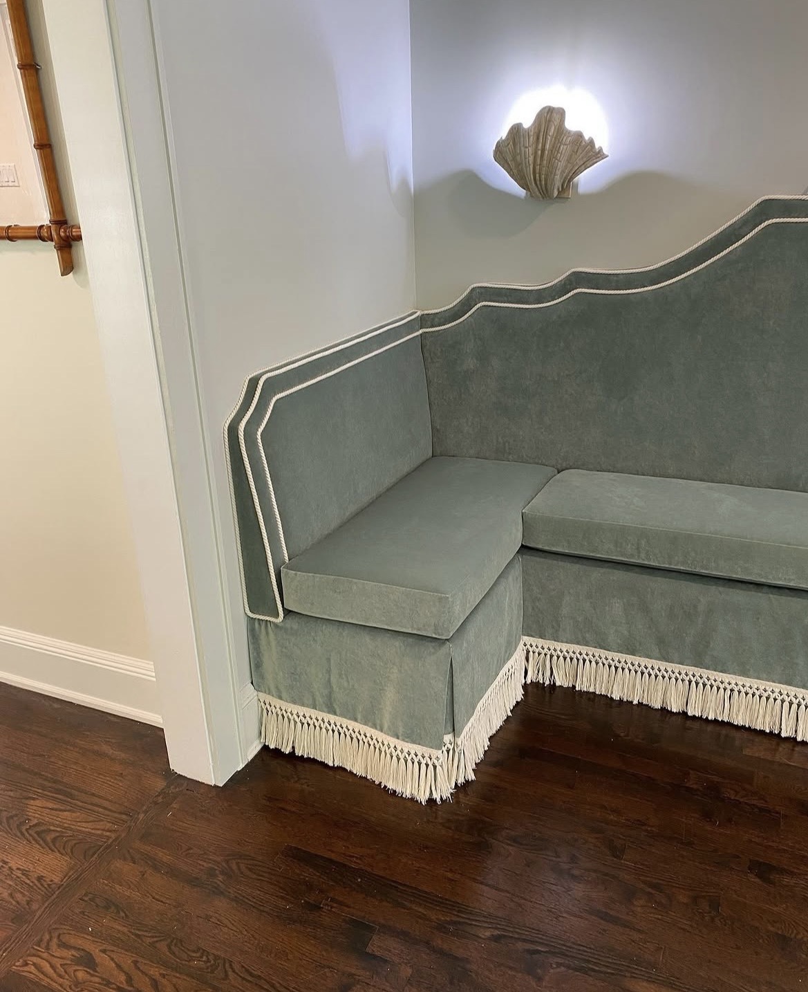 Upholstered corner detail — rope piping and fringe trim on built-in banquette