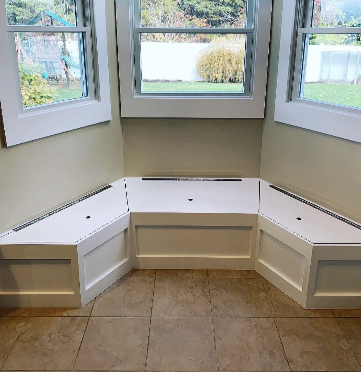 Custom window seat banquette before upholstery — bare built-in frame, Long Island residential project