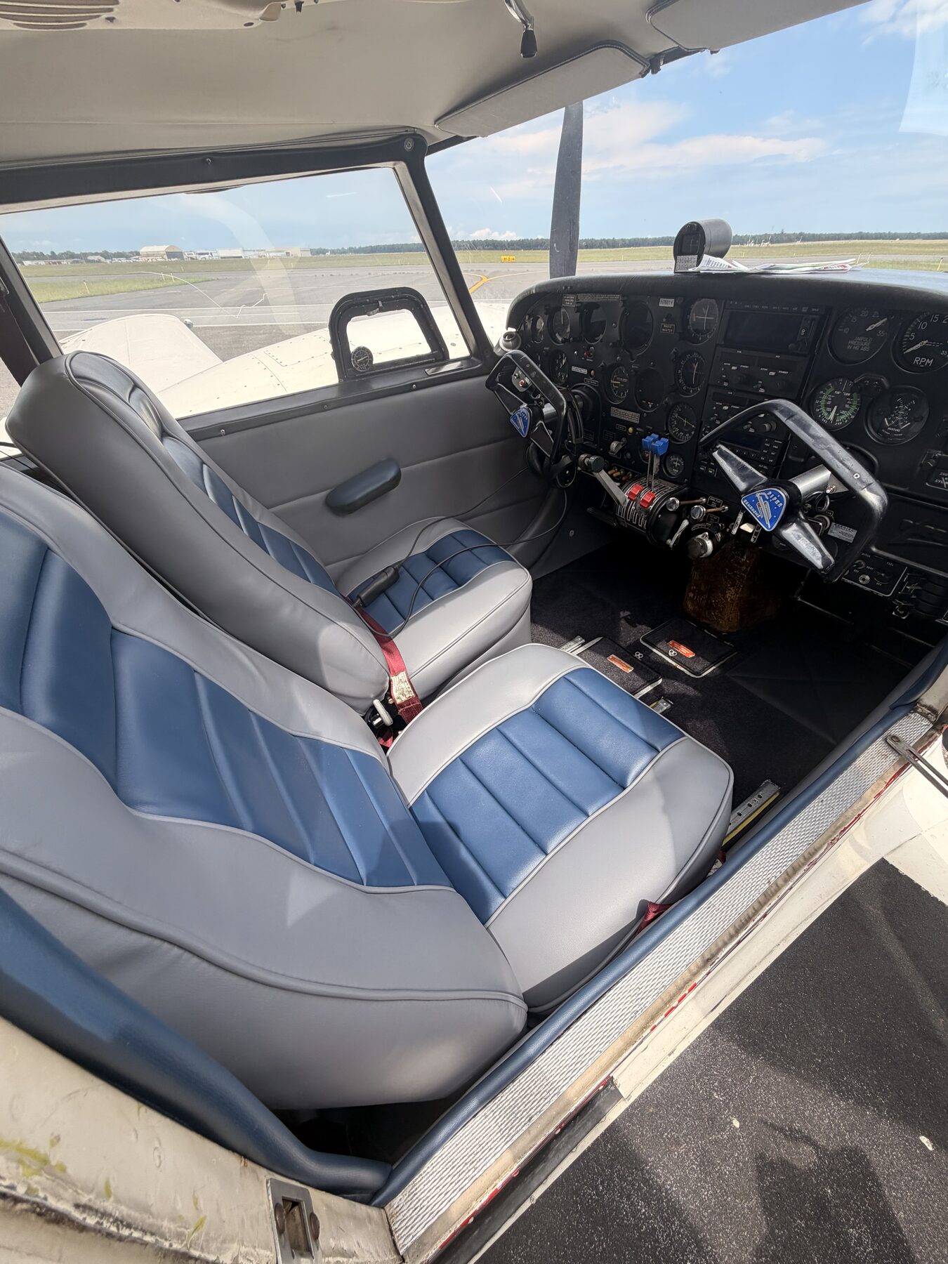 Blue and gray upholstered aircraft cockpit seats
