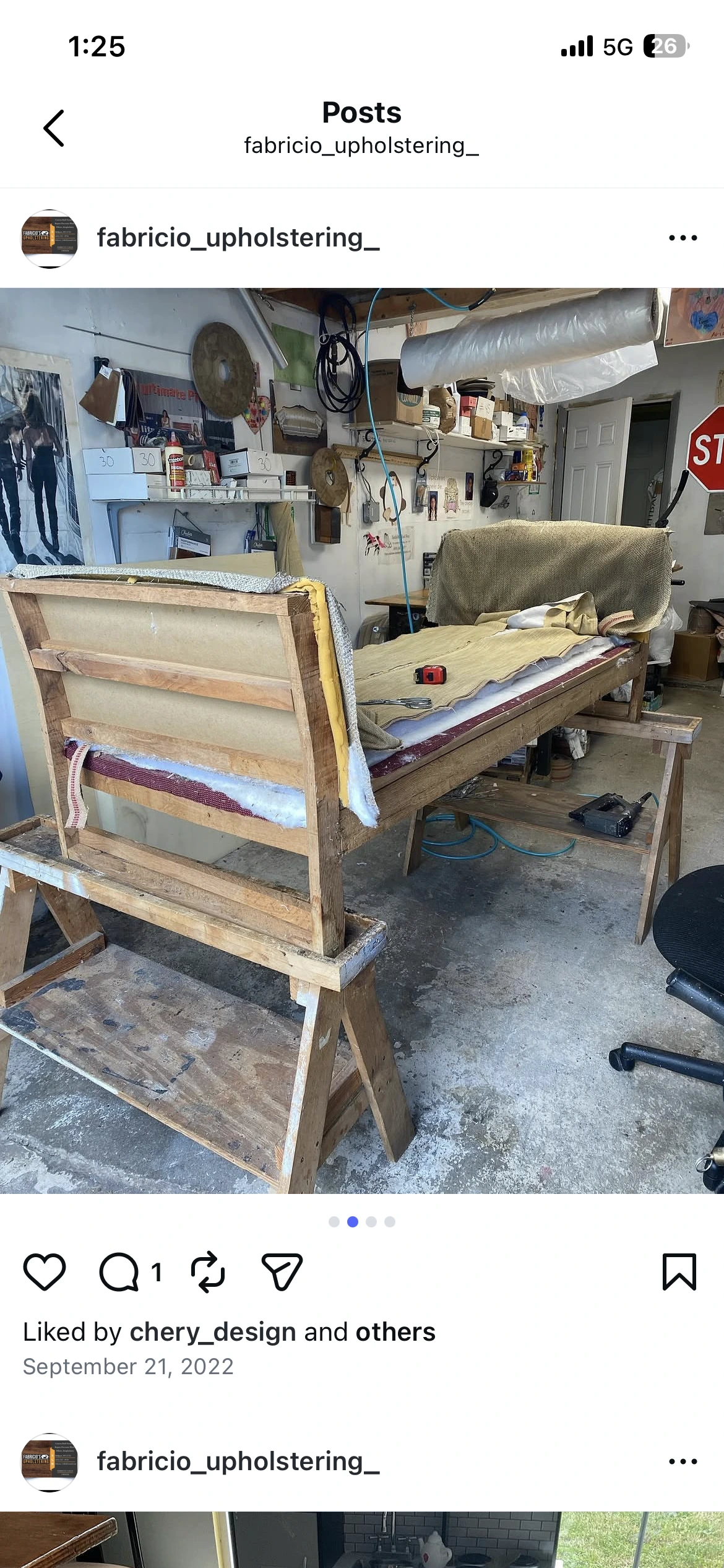 Sofa frame on sawhorses in upholstery workshop — foam layers and burlap visible during rebuild
